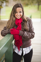 Image showing Pretty Woman Portrait Wearing Red Scarf and Mittens Outside