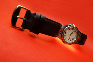 Image showing Watch on a red