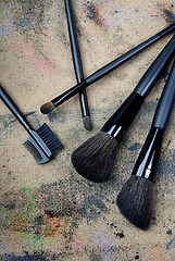 Image showing Five brushes on a dingy background