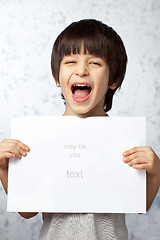 Image showing laughing boy with a poster in hands