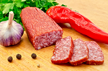 Image showing Salami with vegetables on the board