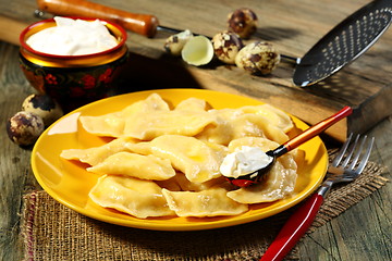 Image showing Dumplings with sour cream.