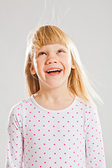 Image showing Happy young girl looking up