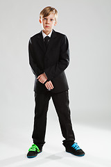 Image showing Young boy in black suit and colorful shoes