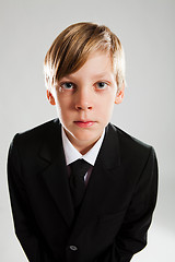 Image showing Serious young boy wearing black suit