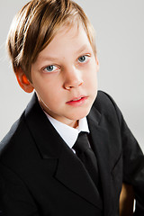 Image showing Young boy wearing black suit