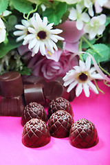 Image showing Chocolate sweets and flowers