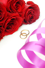 Image showing Holiday ribbon and wedding rings with flowers