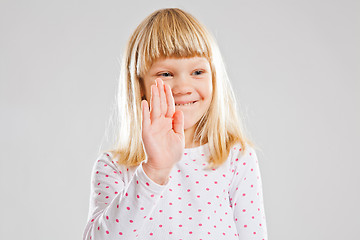 Image showing Smiling young girl showing hand signal