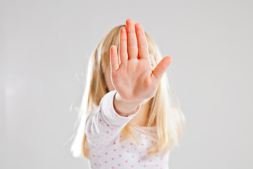 Image showing Young girl showing stop hand sign