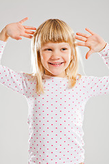 Image showing Happy smiling young girl with raised hands