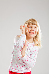 Image showing Happy smiling young girl with raised hands