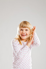 Image showing Happy smiling young girl with raised hands