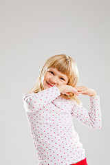 Image showing Happy smiling young girl with raised hands