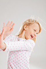 Image showing Happy smiling young girl with raised hands