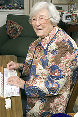 Image showing senior woman at the game table