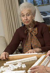 Image showing senior woman at the game table