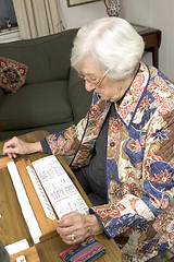 Image showing senior woman at the game table