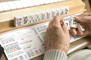 Image showing senior woman at the game table