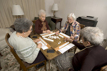Image showing senior woman at the game table