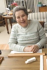 Image showing senior woman at the game table