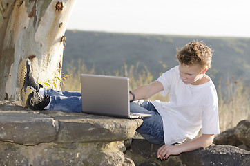 Image showing Guy works on a laptop