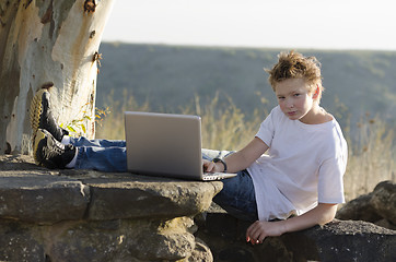 Image showing Serious teen rest with notebook