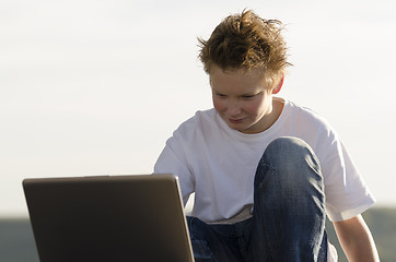 Image showing Schoolboy with laptop