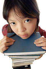 Image showing Pretty girl and stack of books