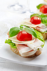 Image showing Sandwich with prosciutto, parmesan cheese and tomato