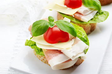 Image showing Sandwich with prosciutto, parmesan cheese and tomato