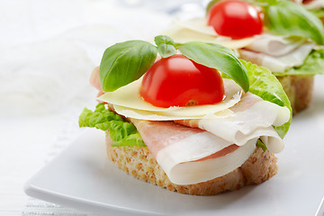 Image showing Sandwich with prosciutto, parmesan cheese and tomato