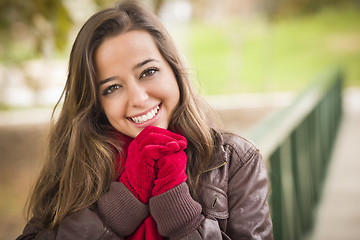 Image showing Pretty Woman Portrait Wearing Red Scarf and Mittens Outside