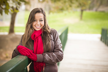 Image showing Pretty Woman Portrait Wearing Red Scarf and Mittens Outside