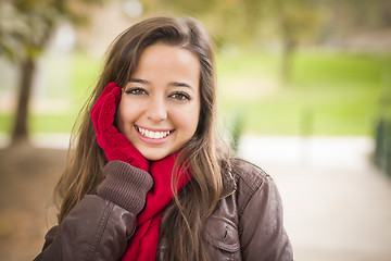 Image showing Pretty Woman Portrait Wearing Red Scarf and Mittens Outside