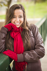 Image showing Pretty Woman Portrait Wearing Red Scarf and Mittens Outside