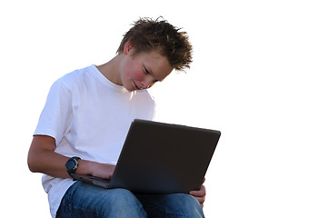 Image showing Teenager with spiky hair work on laptop (isolated on white)