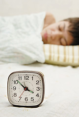 Image showing Alarm-clock and sleepyhead