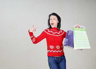 Image showing Woman showing the bags with gifts