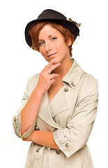 Image showing Attractive Red Haired Girl Wearing a Trench Coat and Hat