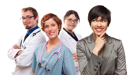 Image showing Young Mixed Race Woman with Doctors and Nurses Behind