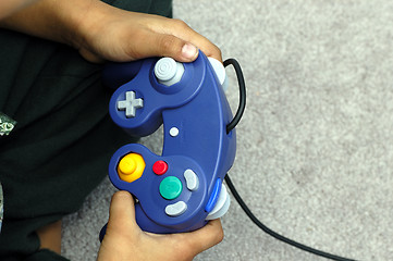 Image showing A kid playing a video game