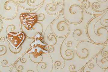 Image showing homemade gingerbreads on christmas background