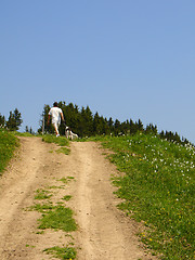 Image showing Man with dog in mountains