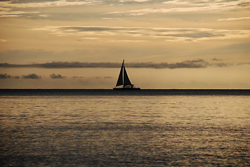 Image showing Sailing boat silhouetted at sunset