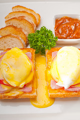 Image showing eggs benedict on bread with tomato and ham