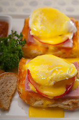 Image showing eggs benedict on bread with tomato and ham