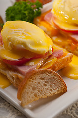 Image showing eggs benedict on bread with tomato and ham