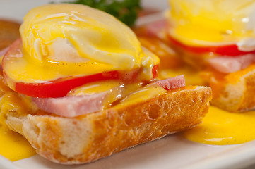 Image showing eggs benedict on bread with tomato and ham