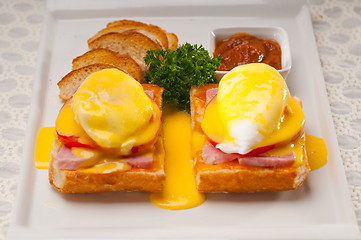 Image showing eggs benedict on bread with tomato and ham